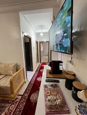 a living room with a flat screen tv on the wall at شقةبالقرب من مطار مراكش المنارة الدولي in Oulad Akkou