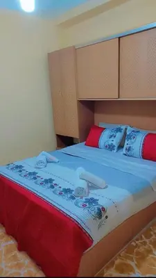 a bedroom with a large bed with blue sheets and pillows at شقةبالقرب من مطار مراكش المنارة الدولي in Oulad Akkou