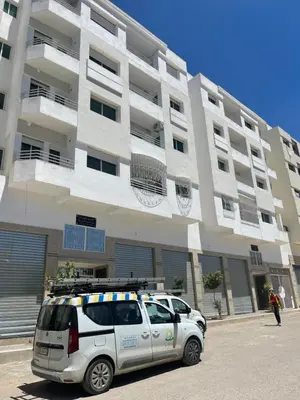 a white car parked in front of a building at Appartement chic fes in Oulad Akkou