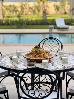 a table with a plate of food on it at Villa Rania Le luxe à Marrakech in Ourika