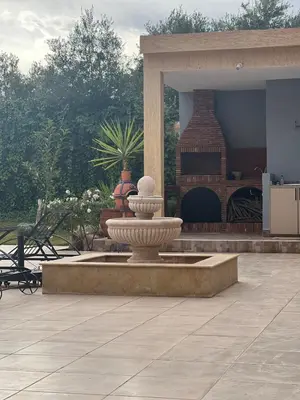 a large fountain in a courtyard with a fireplace at Villa Rania Le luxe à Marrakech in Ourika