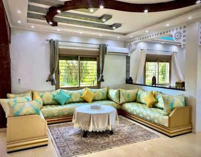 a living room with a couch and a table at Villa Rania Le luxe à Marrakech in Ourika