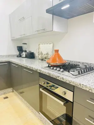 a kitchen with an orange tea kettle on a stove at Villa Rania Le luxe à Marrakech in Ourika
