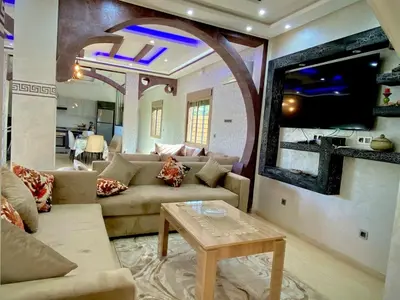 a living room with a couch and a table at Villa Rania Le luxe à Marrakech in Ourika