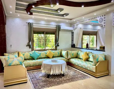 a living room with a couch and a table at Villa Rania Le luxe à Marrakech in Ourika