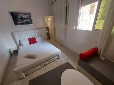a small bedroom with a bed and a window at Hotel Maison Olga in Meknès