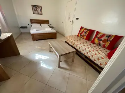 a small room with a bed and a couch at Hotel Maison Olga in Meknès