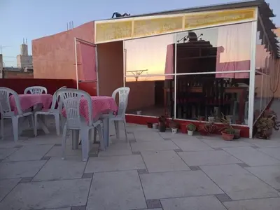 a group of white chairs and tables on a patio at Hotel Maison Olga in Meknès