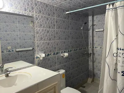 a bathroom with a toilet and a sink and a shower at Hotel Maison Olga in Meknès