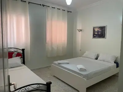 a bedroom with two beds and a window at Hotel Maison Olga in Meknès
