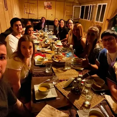 a group of people sitting around a long table at Moha Luxury Camp in Merzouga