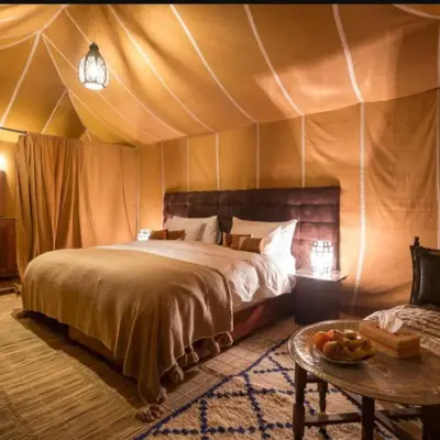 a bedroom with a bed in a tent at Moha Luxury Camp in Merzouga