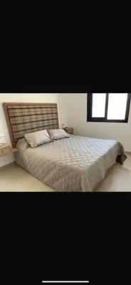 a bedroom with a bed and a window at Cosy appartement in Oulad Akkou