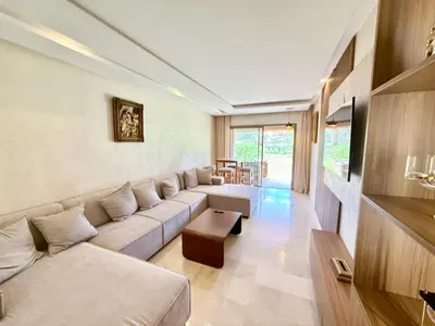 a living room with a couch and a table at Appartement prestigia saphir in Oulad Akkou