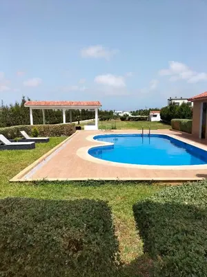 a swimming pool in a yard with a gazebo at Villa piscine espace vert luxueuse in Oulad Akkou