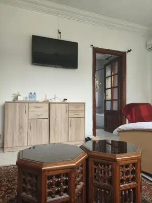 a living room with a flat screen tv on the wall at No21 Loulan Villa21\u53f7\u522b\u5885\u6c11\u5bbf in Oulad Akkou
