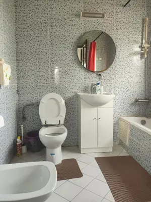 a bathroom with a toilet and a sink and a mirror at No21 Loulan Villa21\u53f7\u522b\u5885\u6c11\u5bbf in Oulad Akkou