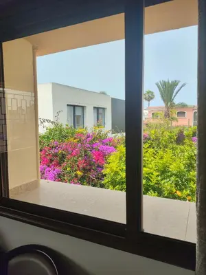 a window looking out at a garden of flowers at No21 Loulan Villa21\u53f7\u522b\u5885\u6c11\u5bbf in Oulad Akkou