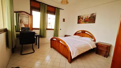 a bedroom with a bed and a desk and a window at No21 Loulan Villa21\u53f7\u522b\u5885\u6c11\u5bbf in Oulad Akkou