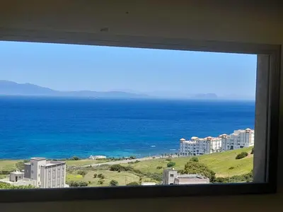 a view of the ocean from a window at diki ksar sghir in Oulad Akkou