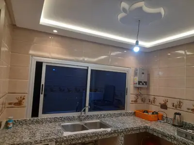 a kitchen with a sink and a large window at diki ksar sghir in Oulad Akkou