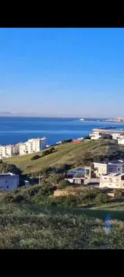 a view of the ocean and a city with buildings at diki ksar sghir in Oulad Akkou