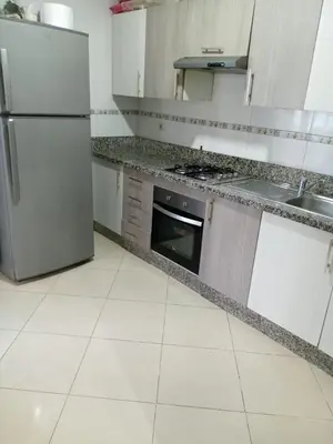 a kitchen with a refrigerator and a sink at Soyer les biens venus in Oulad Akkou