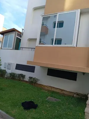 a black bag on the grass in front of a house at Soyer les biens venus in Oulad Akkou