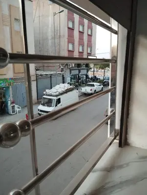 a window view of a parking lot with a white truck at L'airoport in Oulad Tayeb