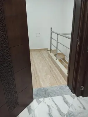 an open door to a room with a wooden floor at L'airoport in Oulad Tayeb