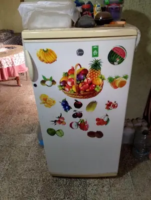 a white refrigerator with fruits and vegetables on it at la maison du belmokhtar Mansour in Douar Sidi Mohammed