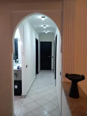an archway leading into a hallway with a bathroom at Alboustane in Oulad Akkou