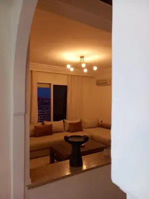 a living room with a couch and a table at Alboustane in Oulad Akkou