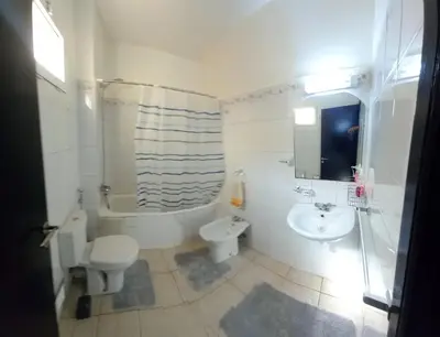 a bathroom with a toilet a sink and a shower at Alboustane in Oulad Akkou
