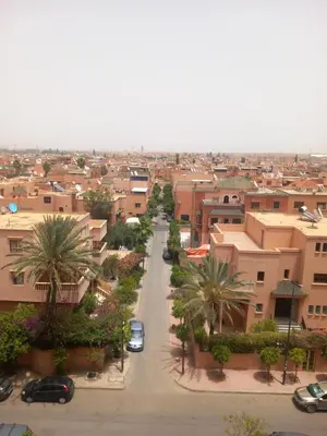 an aerial view of a city with cars driving down a street at Alboustane in Oulad Akkou
