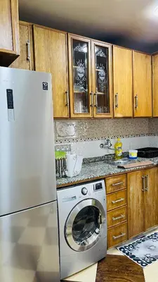 a kitchen with a refrigerator and a washing machine at Appartement de luxe à louer à la journée à Tanger Au centre ville in Fès