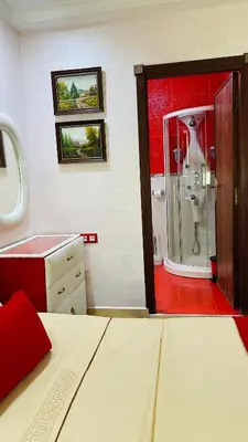 a bathroom with a shower and a bed in a room at Appartement de luxe à louer à la journée à Tanger Au centre ville in Fès