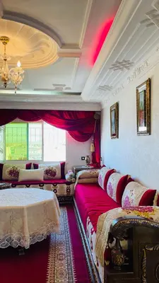a living room with two beds and a couch at Appartement de luxe à louer à la journée à Tanger Au centre ville in Fès