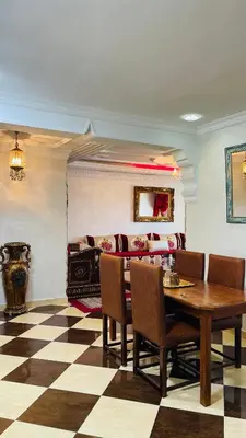 a dining room with a table and chairs at Appartement de luxe à louer à la journée à Tanger Au centre ville in Fès