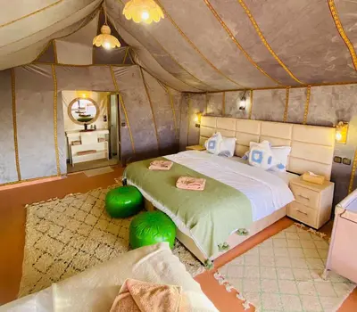 a bedroom with a bed in a tent at Sahara haven camp in Merzouga