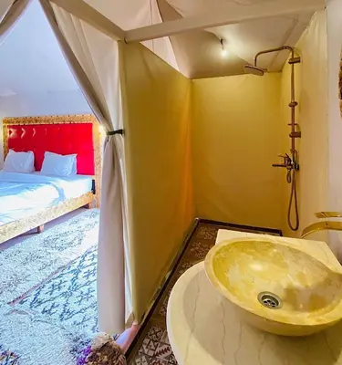 a bathroom with a tub and a sink in a room at Sahara haven camp in Merzouga