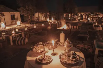 a table with candles and other items on it at Nourland Luxury Camp in Merzouga