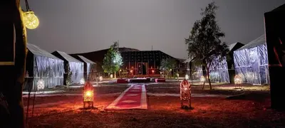 a building with christmas lights in front of it at Villasaharamerzouga in Merzouga