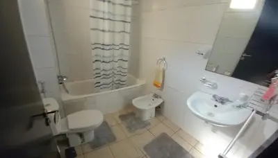 a bathroom with a toilet and a sink and a tub at Al boustane1 in Oulad Akkou