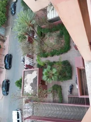 an overhead view of a parking lot with plants at Al boustane1 in Oulad Akkou