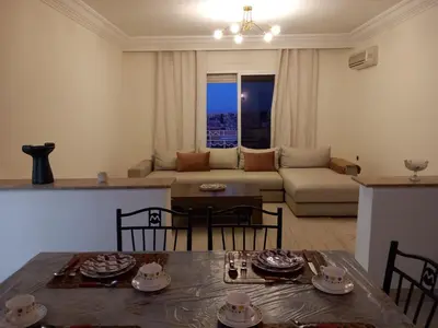 a living room with a table and a couch at Al boustane1 in Oulad Akkou