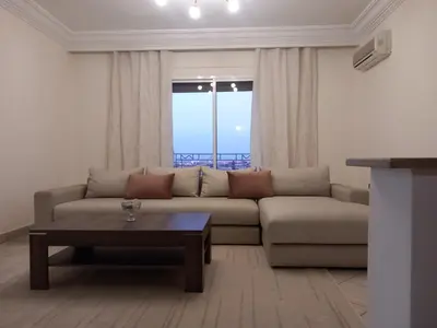 a living room with a couch and a coffee table at Al boustane1 in Oulad Akkou