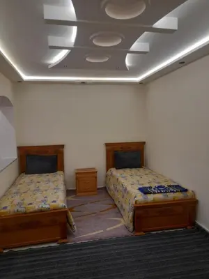 a room with two beds and a ceiling at diki in Oulad Akkou