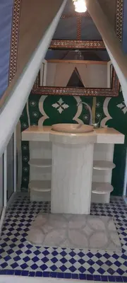 a bathroom with a sink and a tile floor at Bivouac Luxe Le Ciel Bleu in Hassilabied
