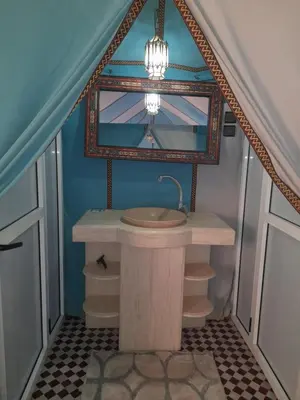 a bathroom with a sink and a mirror at Bivouac Luxe Le Ciel Bleu in Hassilabied